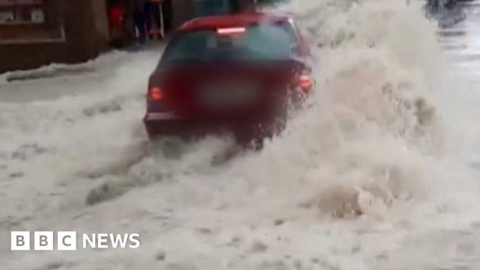 car-swept-backwards-in-raging-spanish-floodwaters